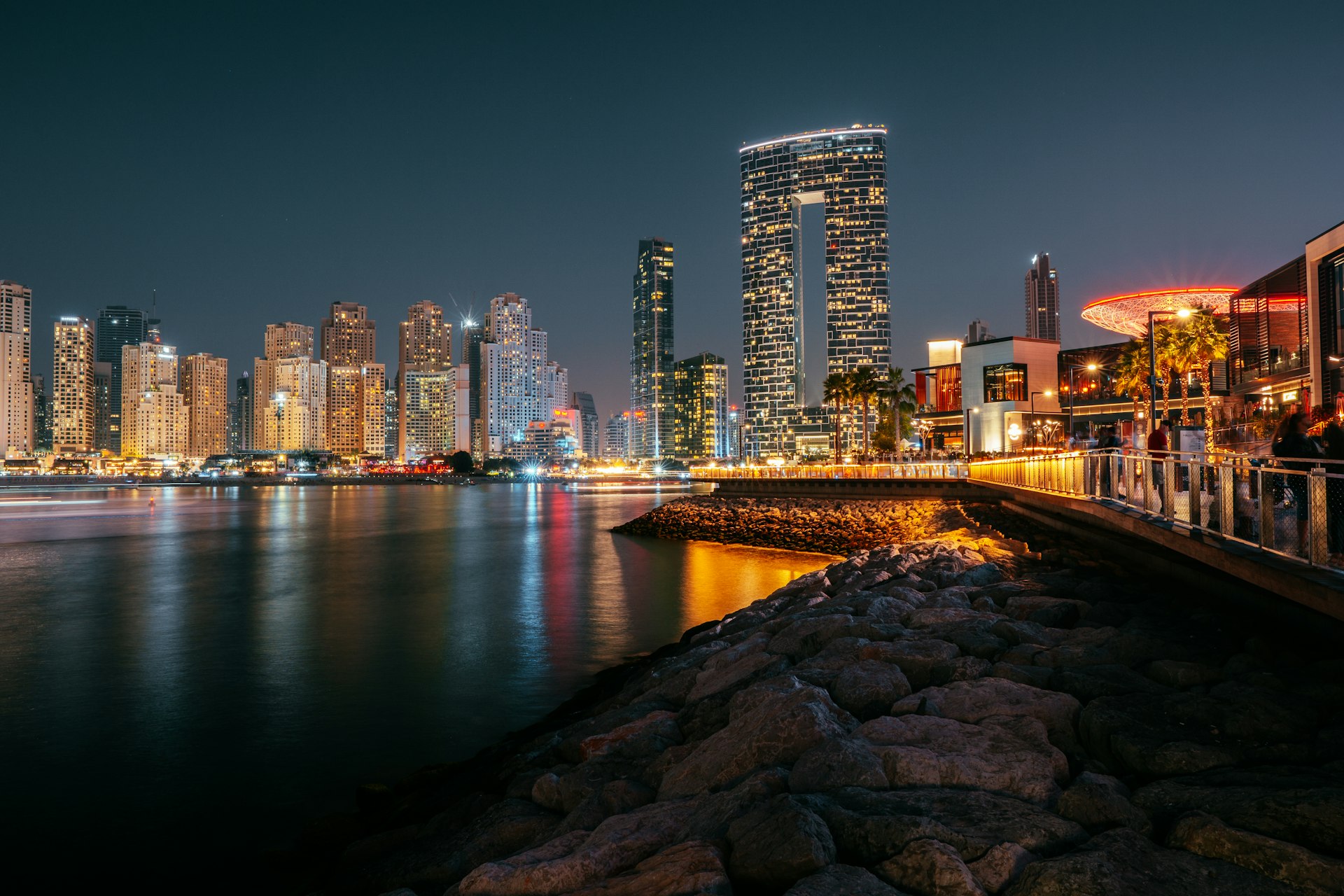 a bridge over a body of water with a city in the background